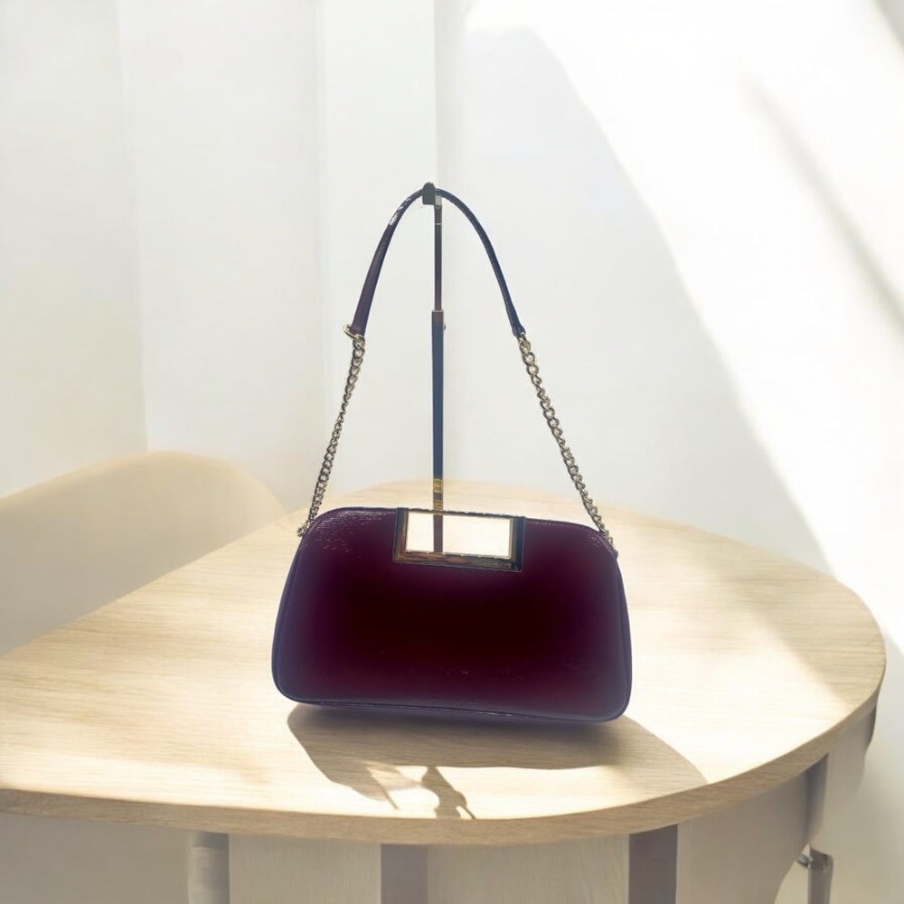 Chic Red Shoulder Bag with Curved Design and Metallic Handle